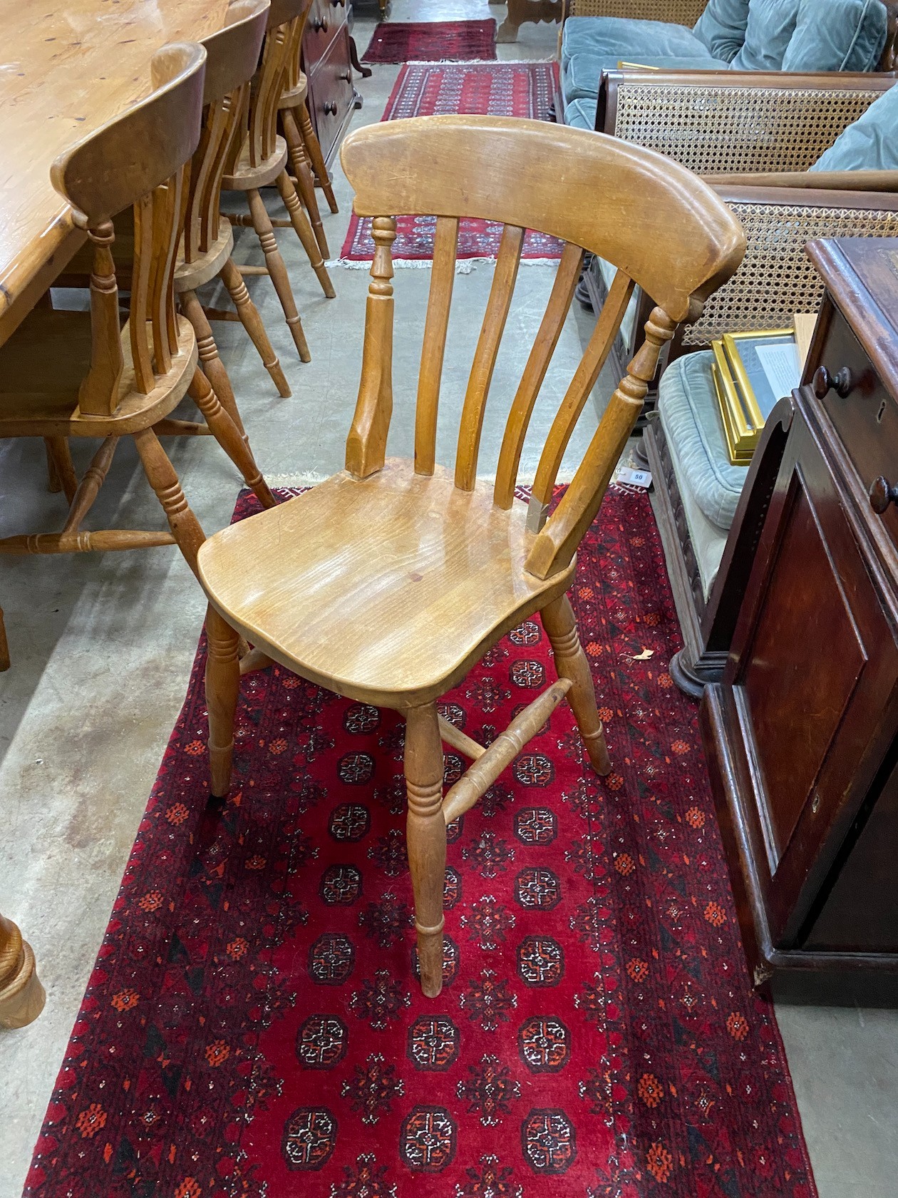 A large Victorian style rectangular pine kitchen table, length 305cm, depth 105cm, height 76cm and ten lathe back beech Windsor kitchen chairs